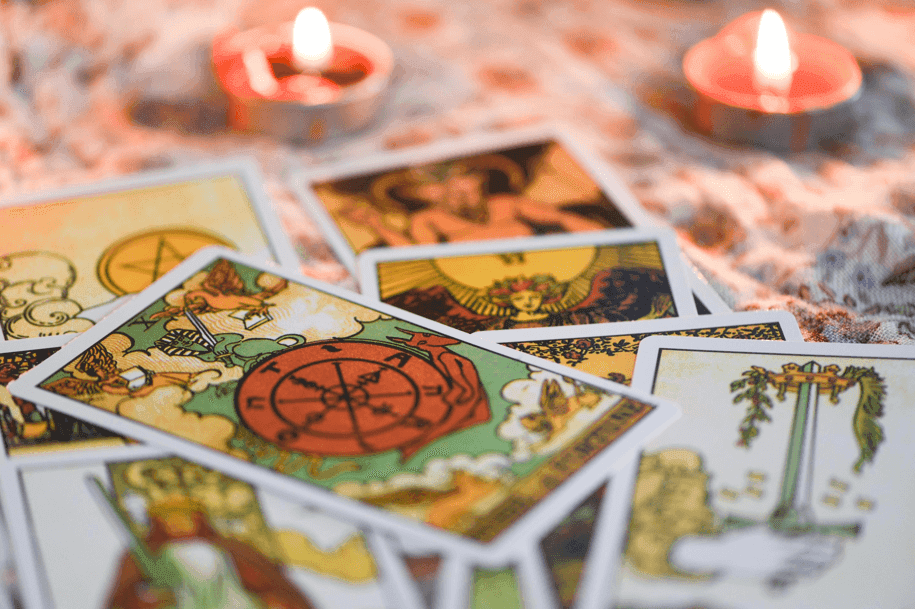 Mystical tarot cards with candles and crystals